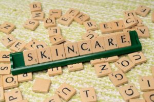 the word skincare is spelled out in scrabble tiles