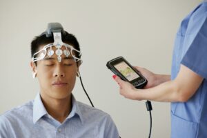 man during examination with use of brainscope